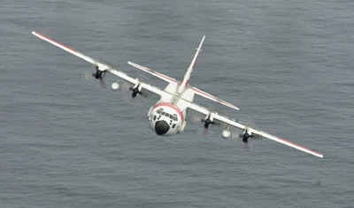 C-130 Flying Over The Ocean